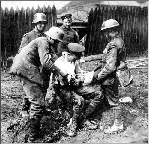 German soldiers dressing a wounded British soldier's wounds